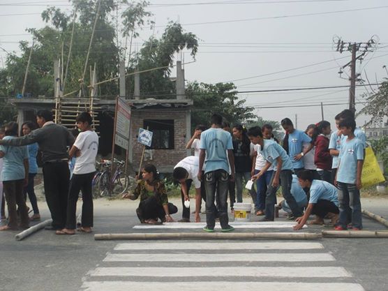 Sunsari Access students painting zebra cross to ease traffic on the road.